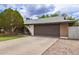 Single-story brick home with attached two-car garage, covered porch, and established landscaping and a driveway at 6869 E Flossmoor Ave, Mesa, AZ 85208