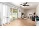 Open living area with a ceiling fan, sliding glass doors, and a view of the fenced backyard at 6869 E Flossmoor Ave, Mesa, AZ 85208