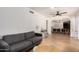 Open-concept living area with sleek hardwood floors, modern decor, and seamless flow to dining space at 6869 E Flossmoor Ave, Mesa, AZ 85208