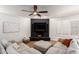 Living room boasts a black brick fireplace, ceiling fan, white walls, and shuttered windows at 6869 E Flossmoor Ave, Mesa, AZ 85208