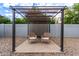 Cozy pergola-covered patio with comfortable seating, creating a relaxing outdoor retreat for conversation and enjoyment at 6869 E Flossmoor Ave, Mesa, AZ 85208