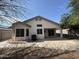 View of the home's backyard with a covered patio and lush landscaping at 7922 W Alex Ave, Peoria, AZ 85382
