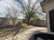 Serene backyard with mature trees and a block wall for privacy at 7922 W Alex Ave, Peoria, AZ 85382