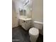 Bathroom featuring toilet, vanity, mirror, and white cabinets at 7922 W Alex Ave, Peoria, AZ 85382