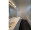 Spacious bathroom featuring double sinks, a soaking tub, and a large mirror at 7922 W Alex Ave, Peoria, AZ 85382