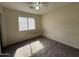 Bedroom with tan walls, brown carpet, and a window that brings in natural light at 7922 W Alex Ave, Peoria, AZ 85382
