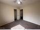 Bedroom featuring carpet, neutral walls, ceiling fan, closet, and hallway access at 7922 W Alex Ave, Peoria, AZ 85382