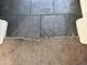 Close up of dark tile flooring transitioning to carpet at 7922 W Alex Ave, Peoria, AZ 85382