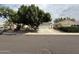 Charming single-story home featuring a lush, mature shade tree and a two-car garage at 7922 W Alex Ave, Peoria, AZ 85382