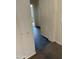 Hallway with light colored walls, dark flooring, and transition to carpet at 7922 W Alex Ave, Peoria, AZ 85382