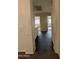 Hallway with light colored walls, dark flooring, and transition to carpet at 7922 W Alex Ave, Peoria, AZ 85382
