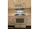 Close up of white oven appliance with cooktop and microwave above at 7922 W Alex Ave, Peoria, AZ 85382