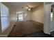 Spacious living room with carpet flooring, a ceiling fan, and sliding glass doors to the backyard at 7922 W Alex Ave, Peoria, AZ 85382