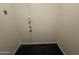 Small room with minimal finishes, electrical outlet, phone jack, and black tile at 7922 W Alex Ave, Peoria, AZ 85382