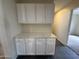 Built-in white storage cabinets and drawers offer ample space, but could use some attention at 7922 W Alex Ave, Peoria, AZ 85382