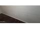 Neutral textured walls show smudges and an electrical outlet over brown carpet at 7922 W Alex Ave, Peoria, AZ 85382
