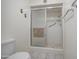 Bathroom with tile floors featuring an accessible shower with a sliding glass door and handrails at 7950 E Keats Ave # 175, Mesa, AZ 85209