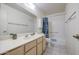 Bathroom with a large mirror, a sink, a toilet, and a tub-shower combination with blue curtains at 7950 E Keats Ave # 175, Mesa, AZ 85209