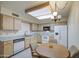 Bright eat-in kitchen with breakfast table, white appliances and light wood cabinetry at 7950 E Keats Ave # 175, Mesa, AZ 85209