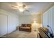 Well-lit room with carpet featuring a lamp, sofa, piano, and two double-door closets at 7950 E Keats Ave # 175, Mesa, AZ 85209