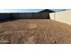The empty backyard is ready for landscaping at 9536 W Parkway Dr, Tolleson, AZ 85353