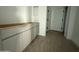 Bathroom features a new vanity with white cabinets and wood-look flooring at 9536 W Parkway Dr, Tolleson, AZ 85353
