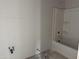 Unfinished bathroom with a new tub and shower and plumbing fixtures ready for completion at 9536 W Parkway Dr, Tolleson, AZ 85353