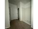 This bathroom features a stand-up shower, wood-look flooring, and entry to closet at 9536 W Parkway Dr, Tolleson, AZ 85353