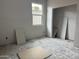 Unfinished drywall bedroom featuring a window, closet space, and electrical outlets at 9536 W Parkway Dr, Tolleson, AZ 85353