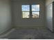 Sunlit bedroom with double windows offering neighborhood views and a closet at 9536 W Parkway Dr, Tolleson, AZ 85353