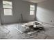 Unfinished bedroom featuring drywall, two windows, and wiring at 9536 W Parkway Dr, Tolleson, AZ 85353