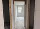 Unfinished drywall bedroom featuring a window and an open door at 9536 W Parkway Dr, Tolleson, AZ 85353