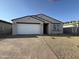 Attractive single-story home with a brick-paved driveway and low-maintenance desert landscaping at 9536 W Parkway Dr, Tolleson, AZ 85353