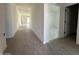 Bright hallway featuring modern wood-style tile flooring leading to various rooms at 9536 W Parkway Dr, Tolleson, AZ 85353