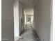 Unfinished hallway showcasing the drywall work and the view of a backyard door at 9536 W Parkway Dr, Tolleson, AZ 85353