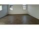 Spacious living room featuring wood-style tile flooring and natural light at 9536 W Parkway Dr, Tolleson, AZ 85353