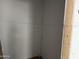 Drywalled corner of a room showing the studs and unfinished flooring under construction at 9536 W Parkway Dr, Tolleson, AZ 85353