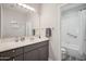 A well-lit bathroom features a neutral palette, a large mirror, and a shower-tub combo at 9600 N 96 Th St # 130, Scottsdale, AZ 85258