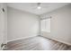 Bright, airy bedroom with wood-look floors, a ceiling fan, and a large window at 9600 N 96 Th St # 130, Scottsdale, AZ 85258