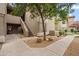 Inviting condo exterior features a private entry with stairs and desert landscaping and mature trees at 9600 N 96 Th St # 130, Scottsdale, AZ 85258
