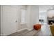 Inviting entryway with wood-look floors, a fireplace, and an orange ottoman at 9600 N 96 Th St # 130, Scottsdale, AZ 85258