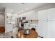 Bright kitchen features white cabinets, stainless steel appliances, and an adjacent dining area for easy meals at 9600 N 96 Th St # 130, Scottsdale, AZ 85258