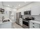 Modern kitchen with stainless steel appliances, white cabinetry, subway tile backsplash, and ample counter space at 9600 N 96 Th St # 130, Scottsdale, AZ 85258