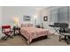 Cozy bedroom with patterned bedding, a side table with lamp, and a music workstation at 9630 W Atlantis Way, Tolleson, AZ 85353