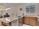 Bright kitchen featuring stainless steel appliances, wooden cabinets and a quartz countertop island with seating at 9630 W Atlantis Way, Tolleson, AZ 85353
