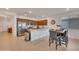 Bright kitchen with stainless steel appliances, wooden cabinets, and breakfast bar with counter seating at 9630 W Atlantis Way, Tolleson, AZ 85353