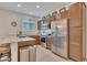 Bright kitchen featuring stainless steel appliances, wooden cabinets and a quartz countertop island with seating at 9630 W Atlantis Way, Tolleson, AZ 85353