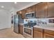 Modern kitchen featuring stainless steel appliances, gas range, and abundant wood cabinetry at 9630 W Atlantis Way, Tolleson, AZ 85353