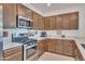 Modern kitchen with stainless steel appliances, ample cabinet space, and a sleek gas range at 9630 W Atlantis Way, Tolleson, AZ 85353