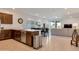 Open-concept living room and kitchen featuring a modern design with sleek finishes and an adjacent dining area at 9630 W Atlantis Way, Tolleson, AZ 85353